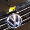 A close up of the grill of a car with a yellow tag on it.
