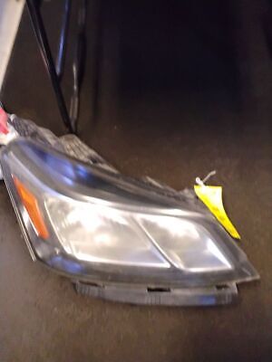 A car headlight with a yellow tag on it.