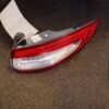 A red and white tail light on the ground
