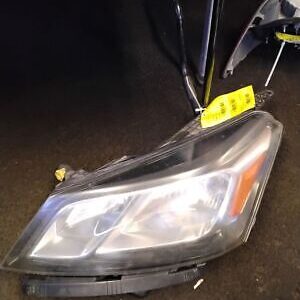 A car headlight with a yellow tag on it.