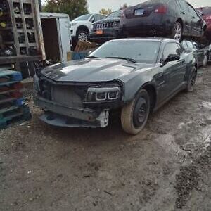 A car that is sitting in the dirt.