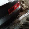 A car that is sitting in the dirt.