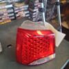A red and white car tail light on top of a table.