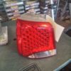 A red and white car tail light on top of a table.