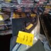 A yellow sign is hanging on the side of a rack.