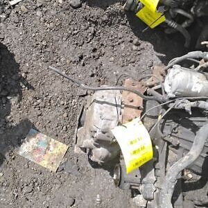 A motorcycle is shown in the dirt with some tags on it.