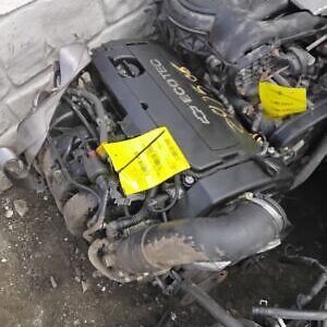 A car engine with yellow tags on it.