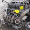 A car engine that is broken down and sitting on the ground.