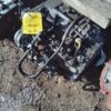 A number of parts on the ground with a yellow tag