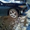 A car that has been wrecked in the snow.