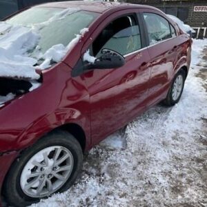 A red car is parked in the snow