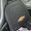 A black seat with an emblem on it.