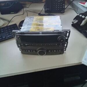 A car radio sitting on top of a desk.