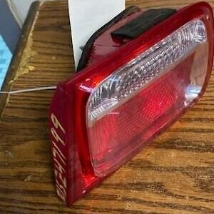 A red tail light sitting on top of a wooden table.