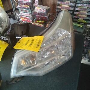 A car headlight with yellow stickers on it