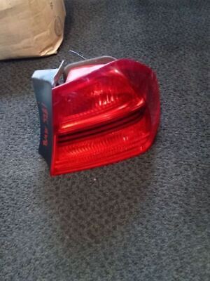 A red tail light sitting on the ground.