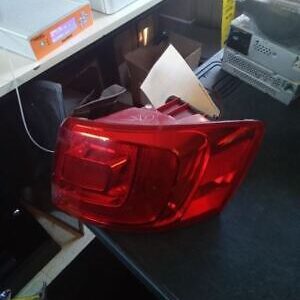 A red car tail light sitting on top of a table.