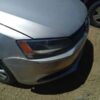 A silver car with the front end dented.