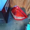 A red and white tail light sitting on top of a table.