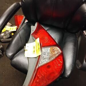 A black leather chair with red and white lights on it.