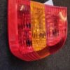 A red and yellow light on the side of a car.