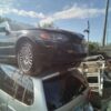 A car that is sitting on top of some other cars.