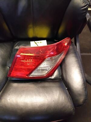 A car 's tail light is sitting on the seat of a chair.