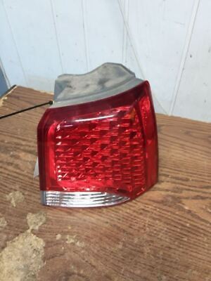 A red tail light sitting on top of a wooden table.
