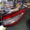 A red car tail light sitting on top of a floor.