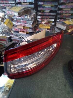 A red car tail light sitting on top of a floor.