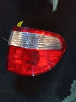 A red and white car tail light on the road.