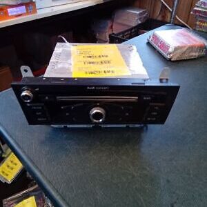 A radio is sitting on the table next to some books.