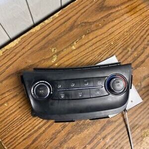 A car radio on top of a wooden table.