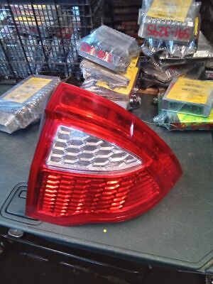 A red and white tail light sitting on top of a table.