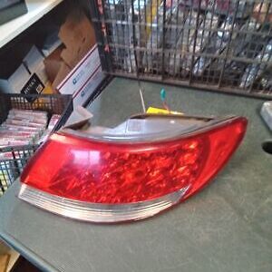 A red and silver car tail light on top of a table.