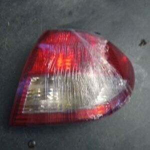 A car 's tail light is covered with plastic wrap.