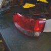 A red and white tail light sitting on top of a table.