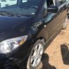 A black car parked on the side of a road.