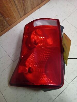 A red tail light sitting on the floor.