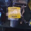 A yellow tag on the side of a metal object.