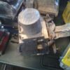 A car engine sitting on top of the floor.
