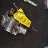 A piece of metal with a yellow tag on it.