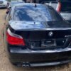 A black bmw parked on the side of a road.