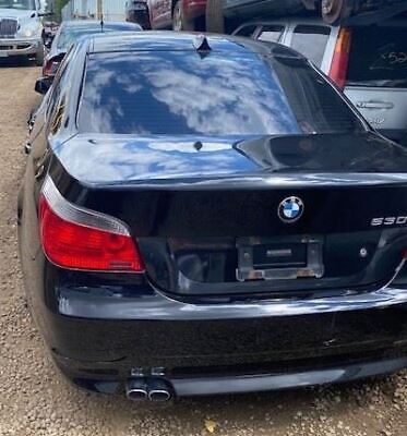 A black bmw parked on the side of a road.
