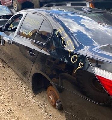 A black car that has been smashed in the back.