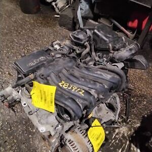 A car engine with some yellow tags on it