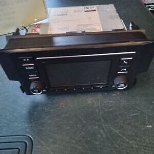 A black and silver car stereo sitting on top of a table.