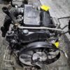 A black engine sitting on top of the ground.