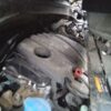 A car engine with the oil leaking out of it.
