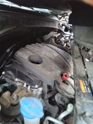 A car engine with the oil leaking out of it.